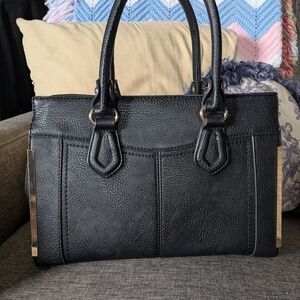 Miztique Black Ladies Handbag With Gold Accents And A Shoulder Strap.